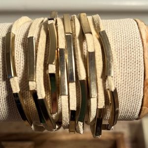 Multi row gold and cream colored leather bracelet.